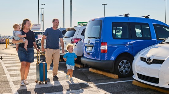 A woman with a luggage trolley in Adelaide Airport's Long Term Car Park